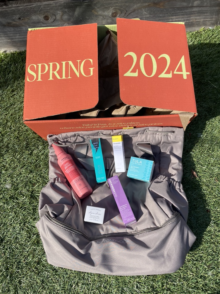 Bag with skincare and makeup products on top of it, under box with Spring 2024 written on it